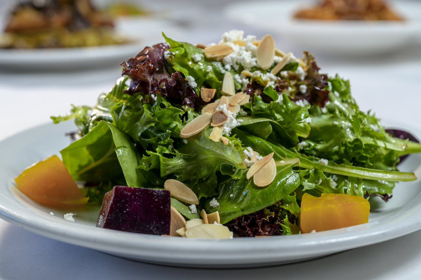 Golden and red beet salad with baby greens, goat cheese and roasted almonds