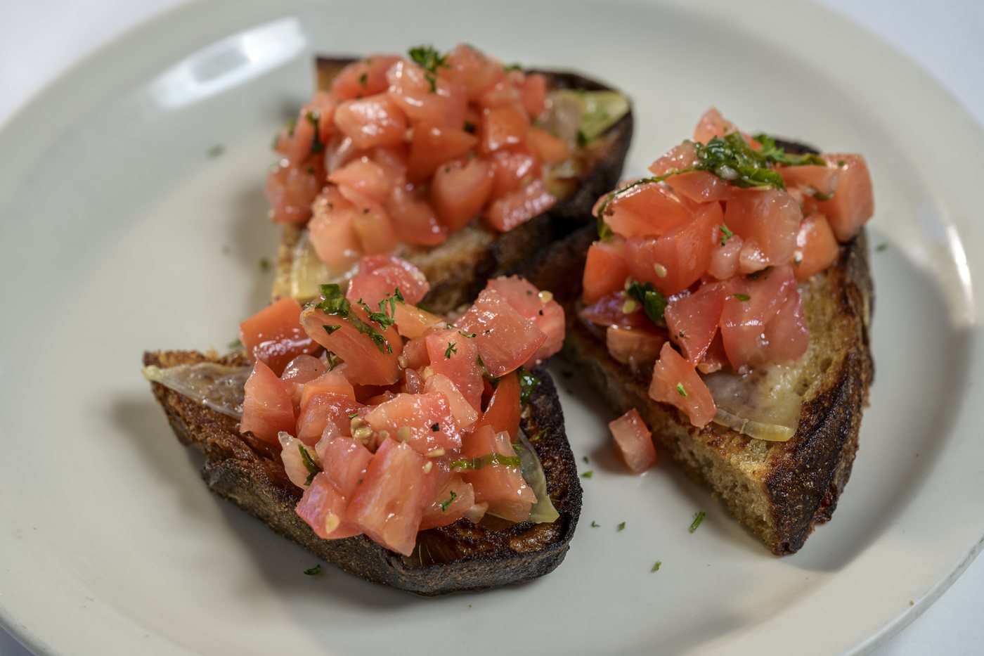 Bruschetta: grilled bread topped with smoked mozzarella and marinated tomato