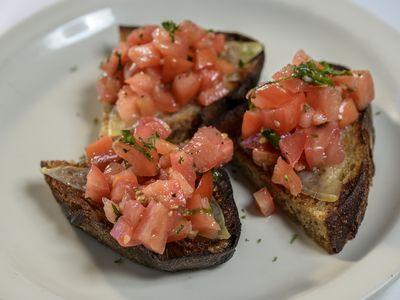 Bruschetta: grilled bread topped with smoked mozzarella and marinated tomato