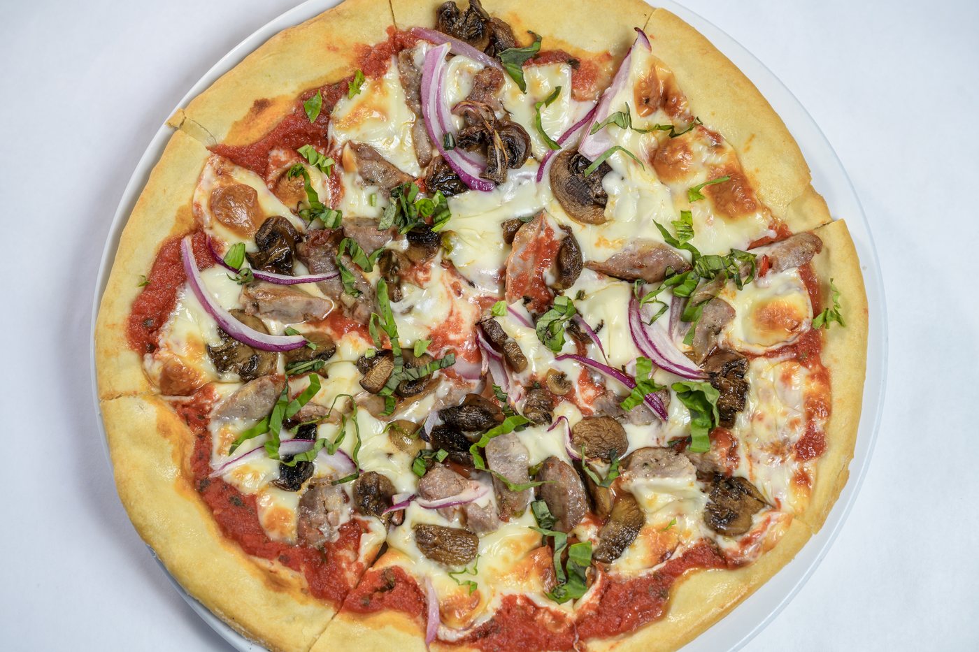 Calabrese pizza with Sicilian sausage, mushrooms, onions and mozzarella
