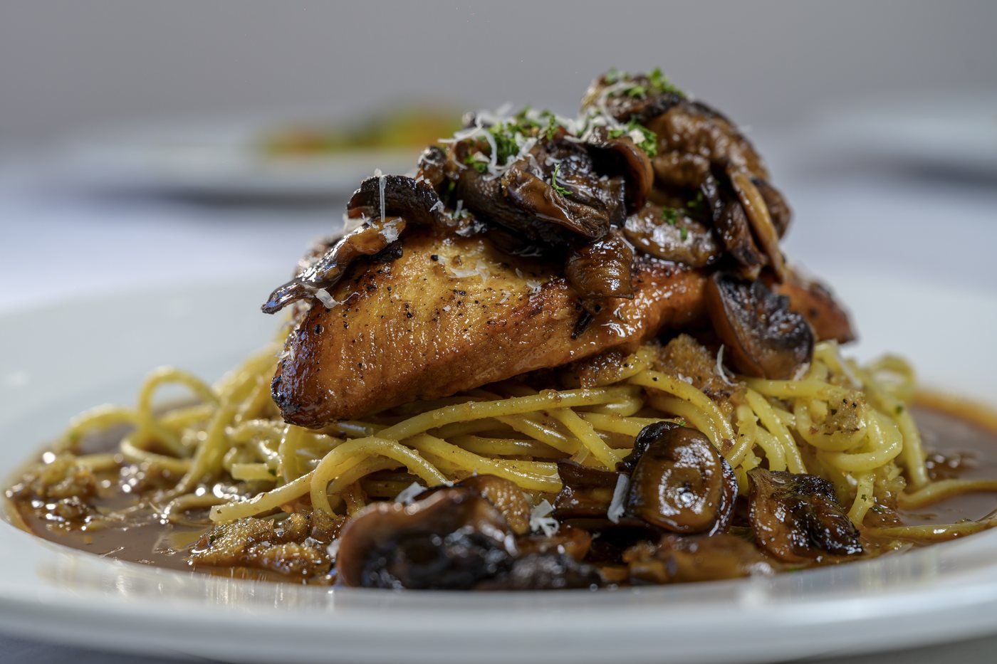 Sauteed chicken breast in mushroom marsala wine sauce over spaghetti