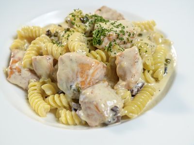 Fusilli pasta with sauteed salmon, kalamata olives and capers in garlic cream sauce