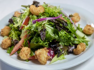 Rock shrimp salad with baby greens, red onion, tomato and cucumber