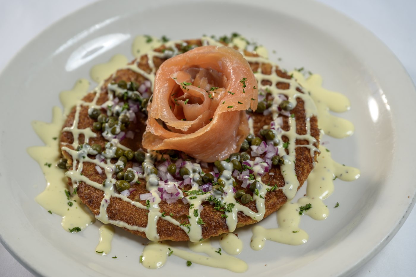 Smoked salmon with capers and red onion on a sweet corn pancake with lemon aioli