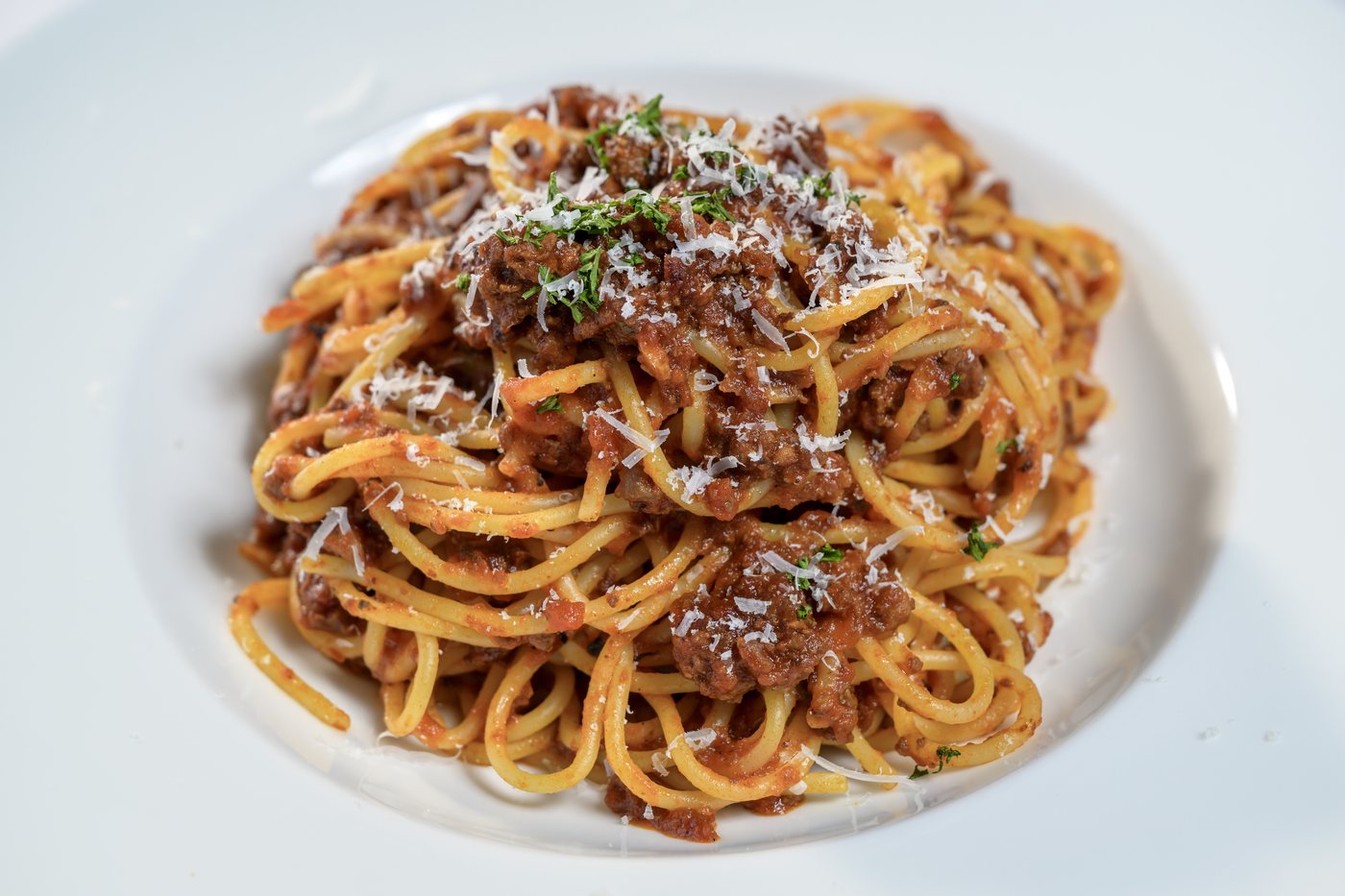 Spaghetti bolognese with ground pork, beef and caramelized onions in herb marinara